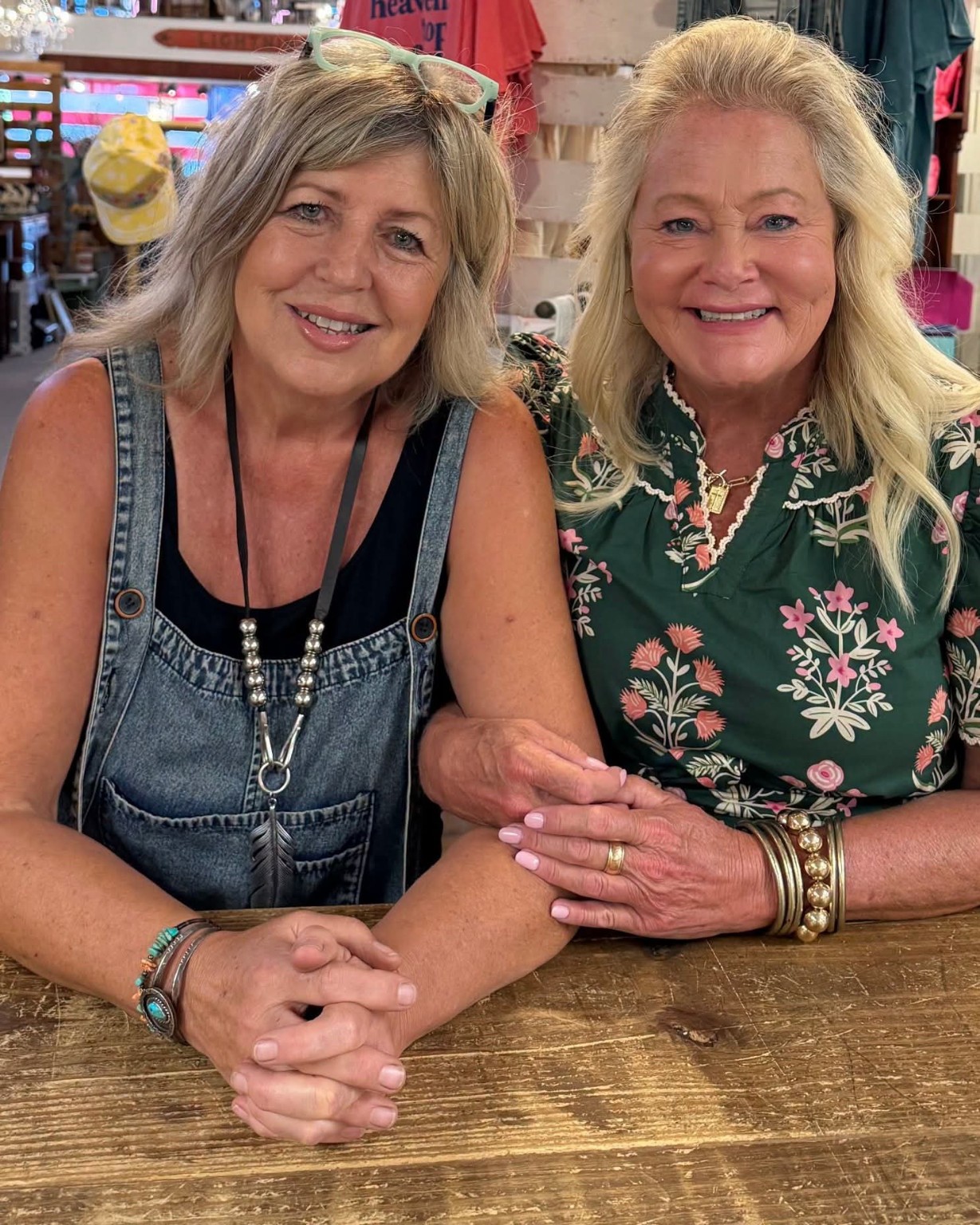 The two owners of Vintage Mercantile smiling together in the shop.
